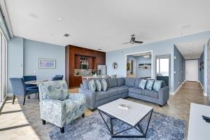a living room with a couch and chairs and a table at PH, Balcony, Lazy River, I-O Pools, Game Room, Spa, Beach, Luxury 2-2 Penthouse! in Galveston