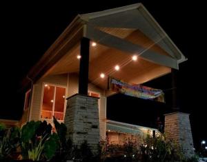 a lit up house with a sign in front of it at night at Rolling Hills Lodge in Cherokee