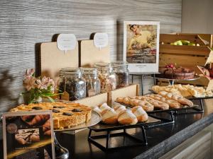 a display of pastries and breads on a counter at Mercure Roma Centro Colosseo in Rome