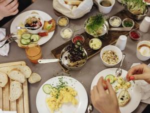 a table topped with plates of food and bread at Sunday Hotel Dortmund City in Dortmund