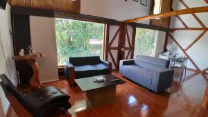 a living room with a couch and a table at Apto/cabaña naranja in Ulloa