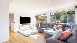 a living room with a couch and a flat screen tv at Sapphire House in Mirador
