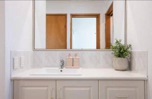 a bathroom with a sink and a mirror at Sapphire House in Mirador +11 photos