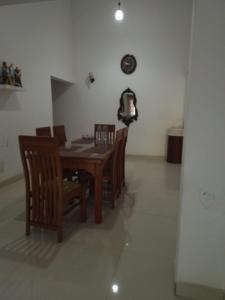 a dining room with a wooden table and chairs at Green Haven by Gapper Sri Lanka in Wattala