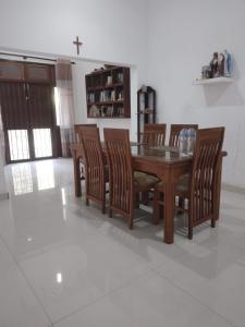 a dining room with a wooden table and chairs at Green Haven by Gapper Sri Lanka in Wattala
