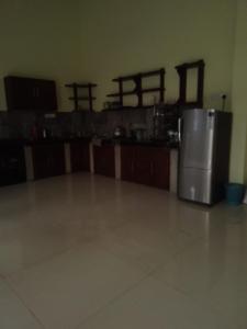 a kitchen with a stainless steel refrigerator in a room at Green Haven by Gapper Sri Lanka in Wattala
