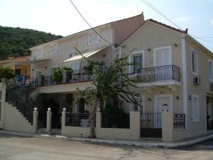 a large white house with balconies on the side of it at Starvillas Apartments and Studios in Agia Effimia