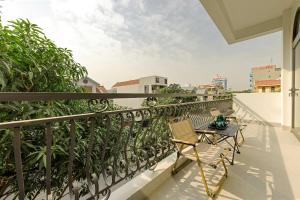a balcony with a table and chair on a balcony at Zen House Ninh Bình in Ninh Binh