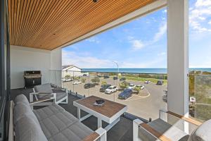 a living room with a view of a parking lot at Mirani's Penthouse in Port Adelaide