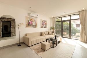a living room with a couch and a fireplace at Zen House Ninh Bình in Ninh Binh