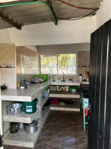 a kitchen with a counter and a sink at Cabañas Cambaro in Puerto Escondido