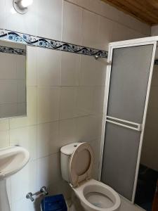 a bathroom with a toilet and a sink and a shower at Cabañas Cambaro in Puerto Escondido +37 photos