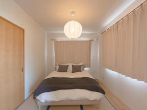 a bedroom with a bed and a chandelier at TOYA Station Villa in Lake Toya +71 photos