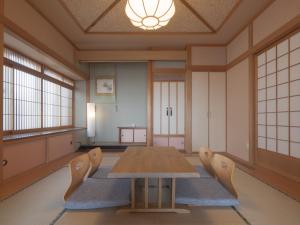 a conference room with a wooden table and chairs at TOYA Station Villa in Lake Toya