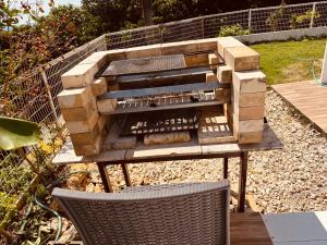 a fire pit in a garden with a table and chairs at 海之恋 in Arazato