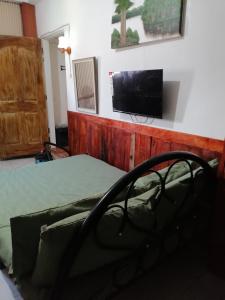 a bedroom with a bed and a flat screen tv at Maraño's Home in Legazpi +78 photos