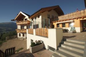 a large house with a balcony and stairs at Solerhof in Laion