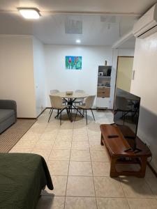 a living room with a table and a dining room at Studio VAI in HUH