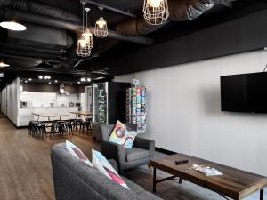 a living room with two couches and a table at The Pod Sydney in Sydney