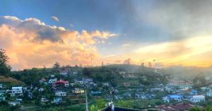 a group of houses on a hill at sunset at Himidiri Villa in Nuwara Eliya