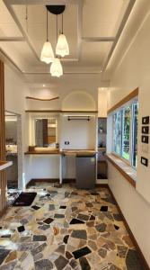 a kitchen with a stone floor and a ceiling with lights at Lake Hill Resort Kanchanaburi in Tha Kradan