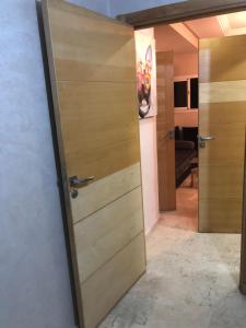 a door leading into a room with a bedroom at Suites Confort Paris & Orly in Villeneuve-Saint-Georges