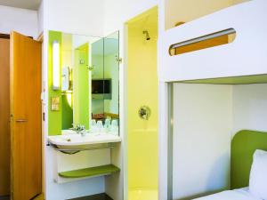 a bathroom with a sink and a mirror at ibis budget Glasgow in Glasgow +43 photos