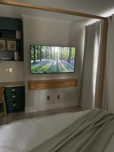 a bedroom with a flat screen tv on a wall at The Tamara Suite in Pensacola