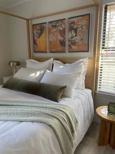 a bedroom with a large bed with white pillows at The Tamara Suite in Pensacola