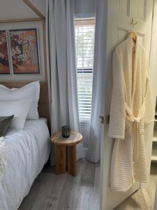 a bedroom with a bed and a table next to a window at The Tamara Suite in Pensacola