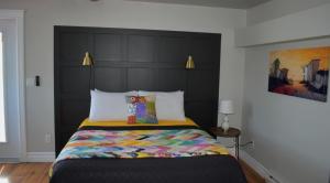 a bedroom with a bed with a black headboard at Parkers Blue Water Inn in Pilleyʼs Island