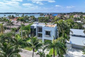an aerial view of a white house with palm trees at Heated Pool & Rooftop Near Intracoastal in Boynton Beach