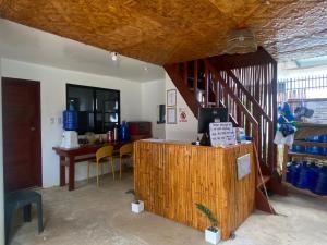 a room with a counter and a table with chairs at Be My Guest Hostel in Panglao Island
