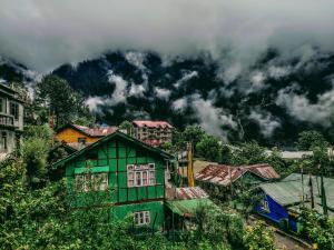 a group of houses in front of a mountain at Hotel Sunrise in Lachen