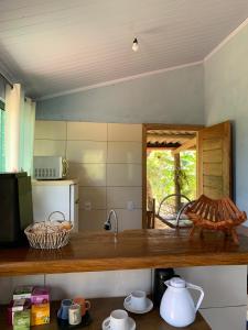 a kitchen with a counter top with a sink at Casa mussambé in Sao Jorge