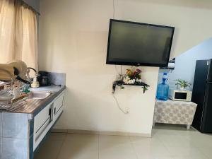 a kitchen with a flat screen tv on the wall at Vista colonial suite in Comayagua