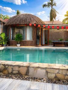 a house with a swimming pool in front of a building at Sora Traditional Homestay in Ninh Binh