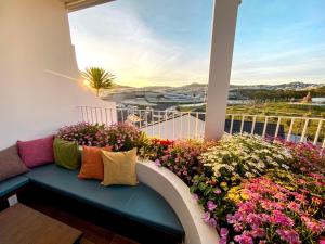 a balcony with a bench and flowers on it at Mộc Villa DaLat in Khu Chi Lăng