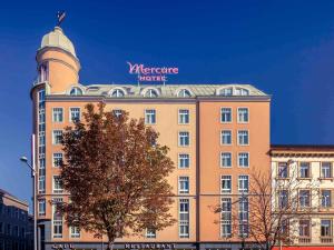 a building with a tower on the top of it at Hotel Mercure Wien Westbahnhof in Vienna