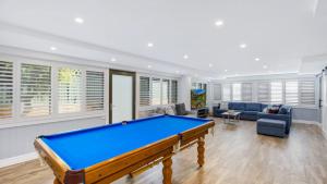 a living room with a pool table in it at Avoca Dream in Avoca Beach +10 photos