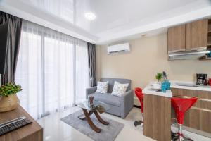 a living room with a couch chair and a table at LUMA Condo 1BR Open View NBC Nai Harn in Rawai Beach