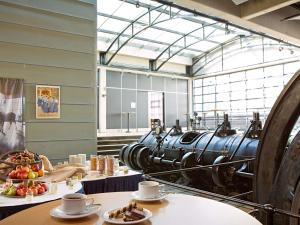 a room with plates of food and a large cannon at Novotel Hannover in Hannover