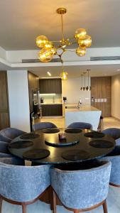 a dining room with a table and chairs and a kitchen at Sonoran Star Luxury 3 Bedroom Breachfront Condominium in Puerto Peñasco