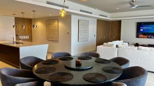a dining room with a table and some chairs at Sonoran Star Luxury 3 Bedroom Breachfront Condominium in Puerto Peñasco