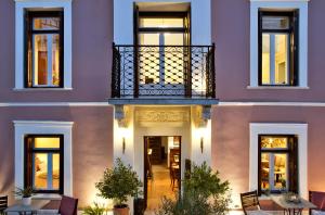 a facade of a building with a balcony at Αρχοντικό Ταξίμι - Ανθέων Έμπνευση in Argalasti