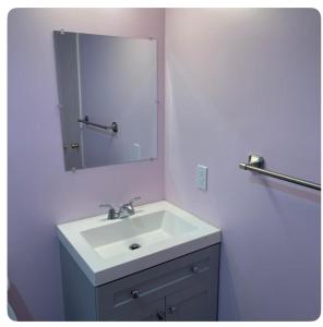 a bathroom with a white sink and a mirror at Bedroom in the basement Upland F in Edmonton