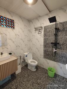 a bathroom with a toilet and a sink and a shower at Glamping Dieng New in Diyeng +27 photos