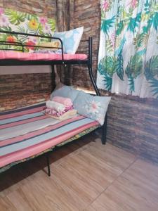 a bench with a pillow and pillows on it at Maraño's Home in Legazpi