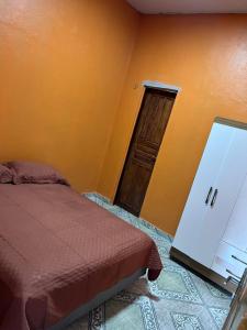 a bedroom with a bed and an open door at Casa dos Lopes in Presidente Figueiredo
