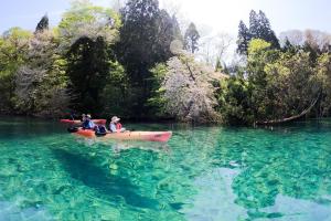 a group of people in a kayak in the water at Katamaeyama Forest Park Cottage TypeC in Senboku